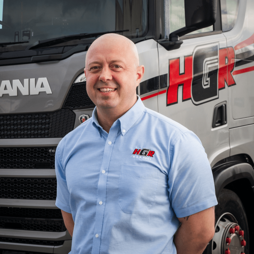 Alan stood in front of an H&R Gray Truck