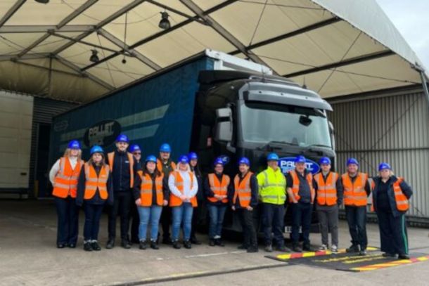 People in high-viz standing in front of truck