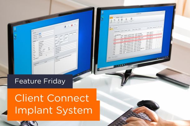 Person typing on keyboard with two monitors with software open