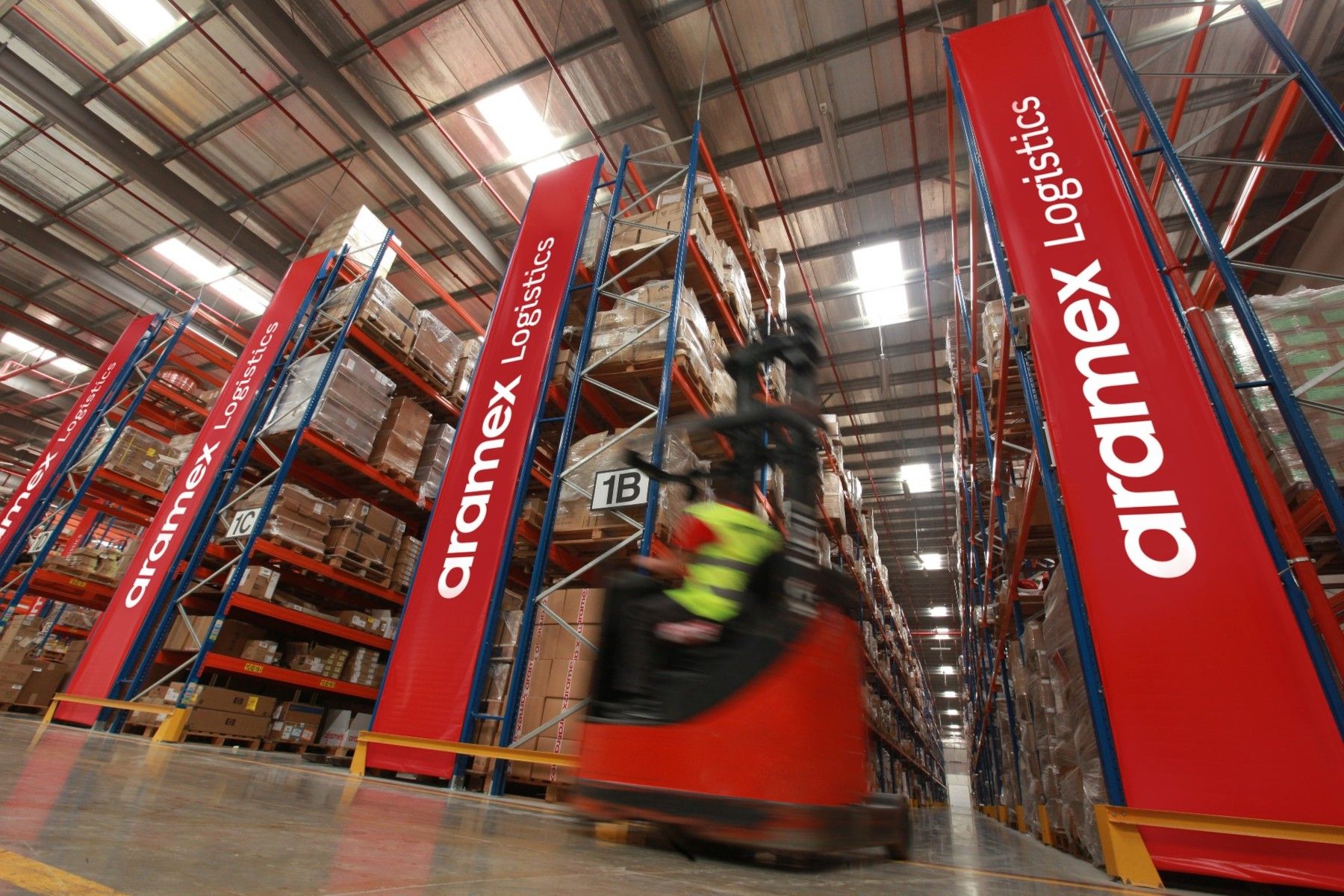 Person Driving Forklift in Warehouse