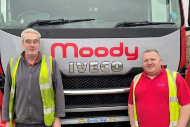 Two Men Standing in front of Moody Iveco Lorry