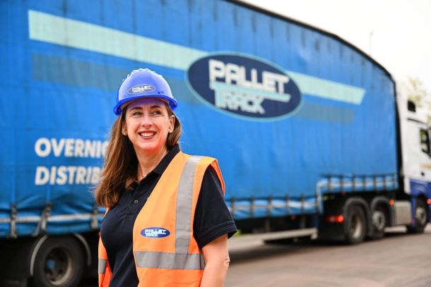Caroline Green in front of a Lorry
